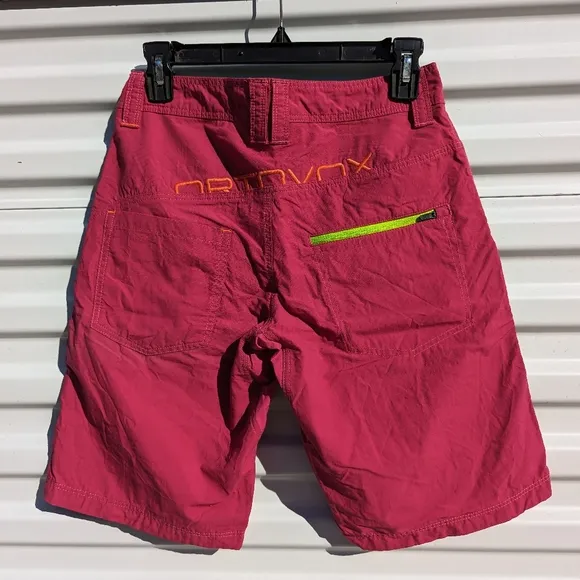 Ortovox fuscia hiking shorts with yellow and orange accents