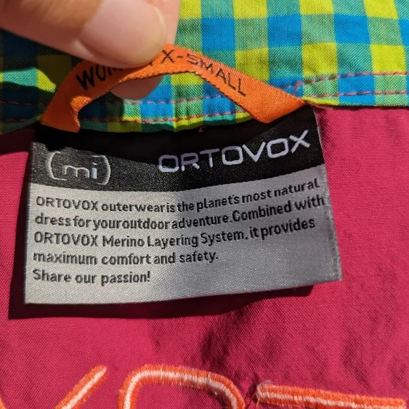 Ortovox fuscia hiking shorts with yellow and orange accents