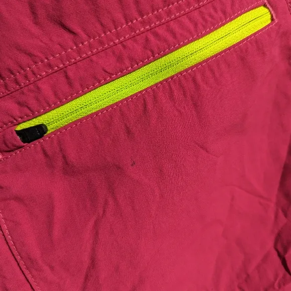Ortovox fuscia hiking shorts with yellow and orange accents